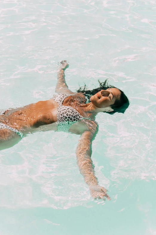 a woman swimming in a large pool of water