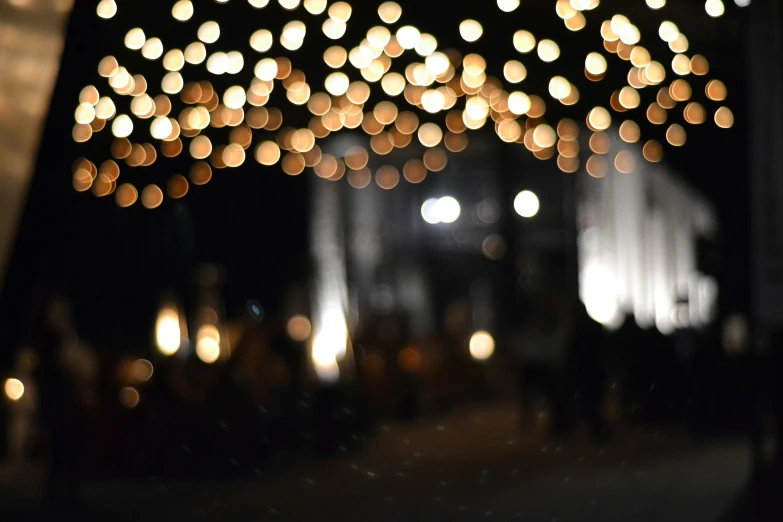 a dark po with lights hanging over the walkway