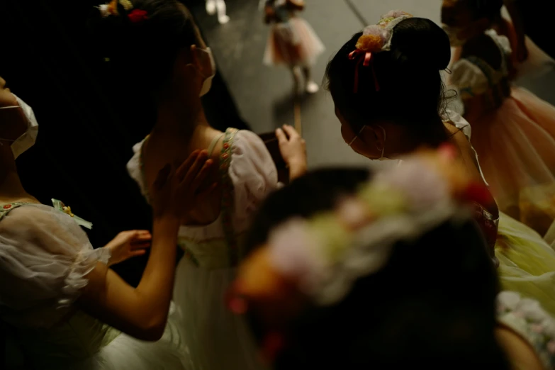 girls dance while another girl holds her hand to their hip