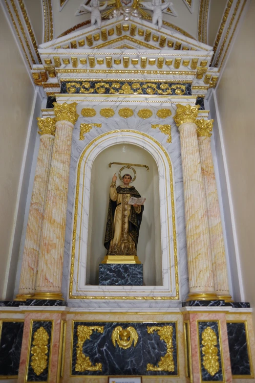 a statue on a stand inside of a church