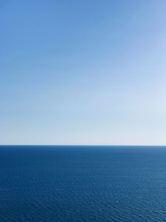 view of the ocean and a bench in front of it