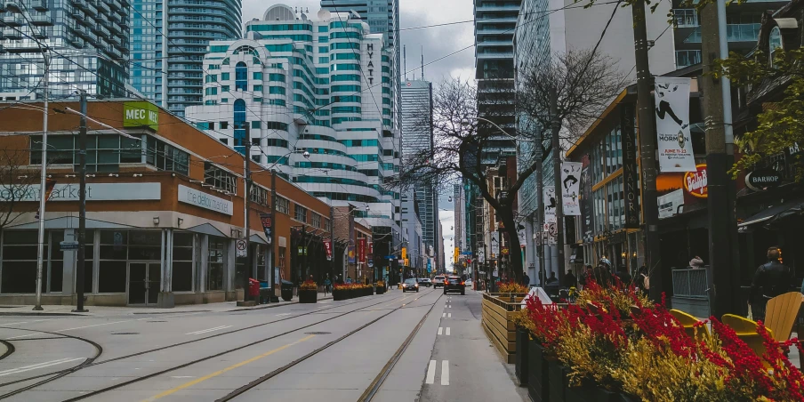 a city with a road, street cars and tall buildings