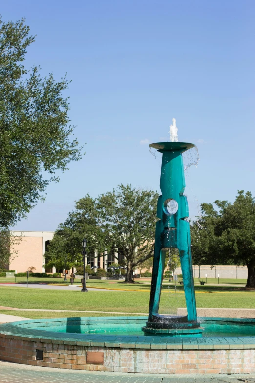 a blue statue sitting in the middle of a field