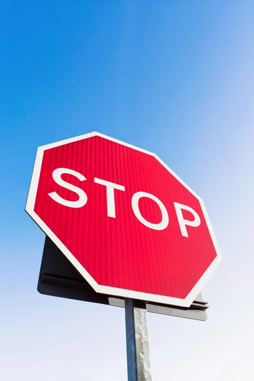 a large red stop sign sitting on top of a metal pole