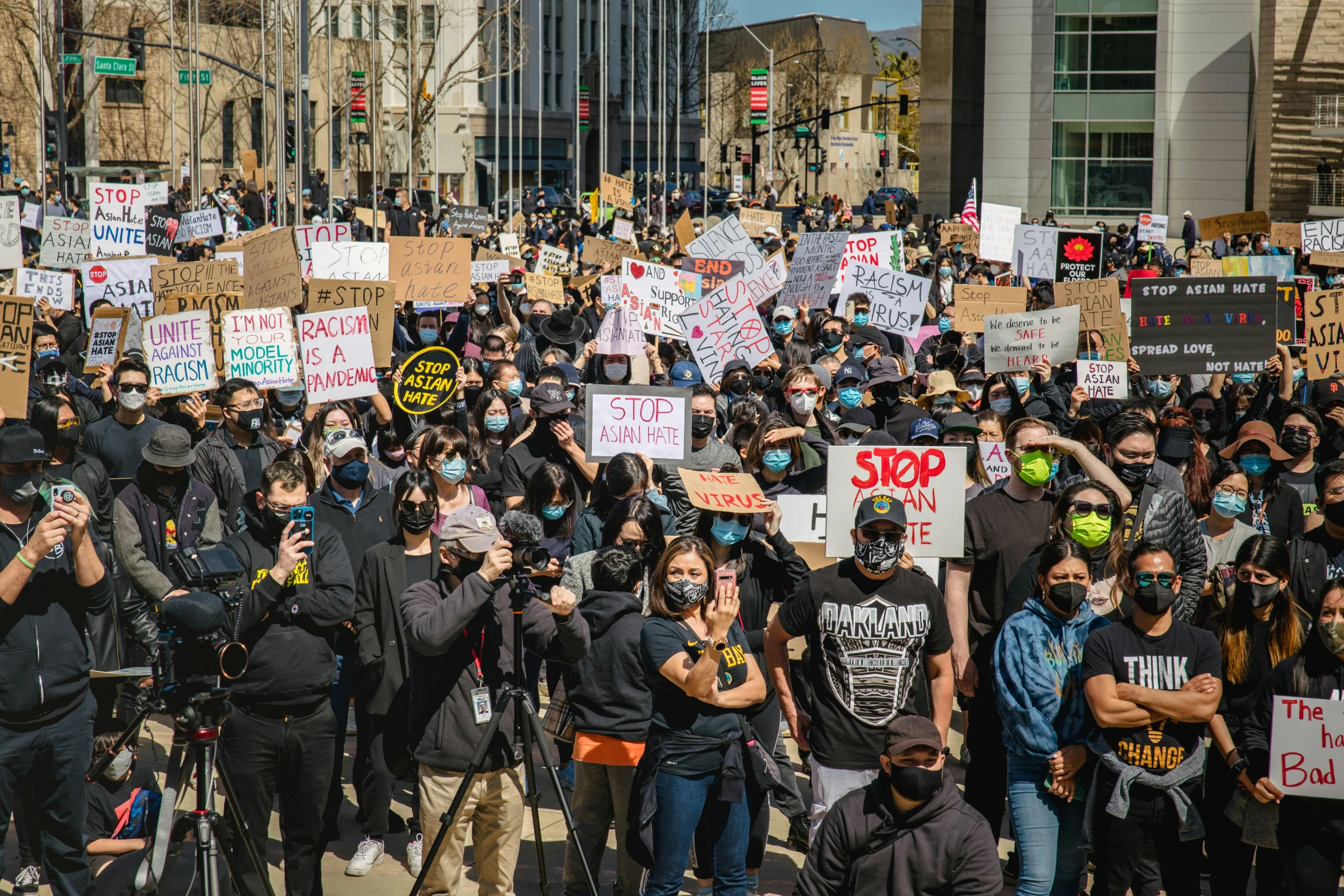 a large group of people in protest and holding signs