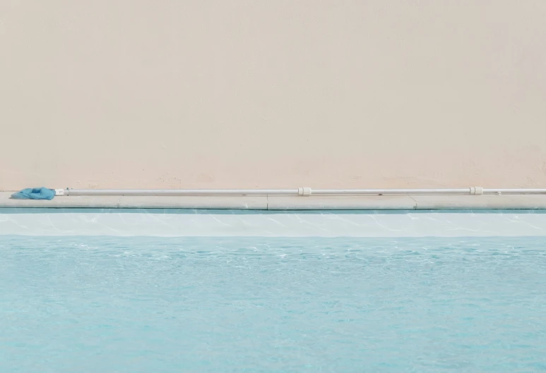 a man sitting on a chair next to a pool