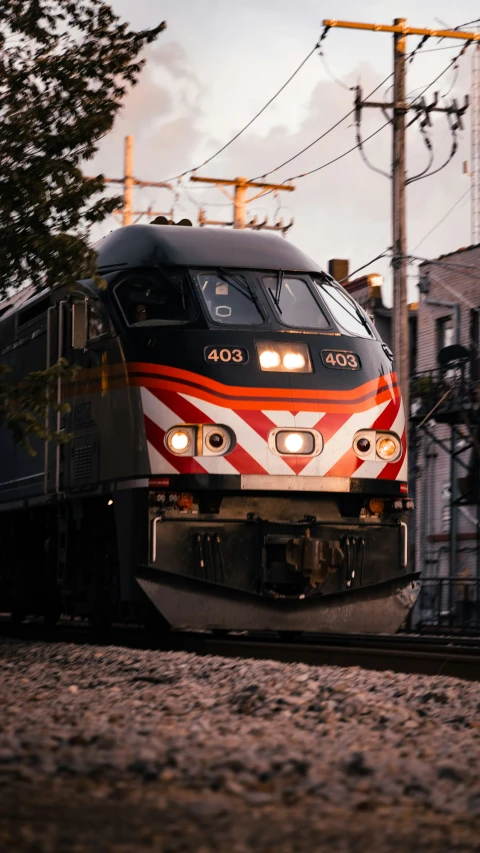 a train moving along the track at dusk