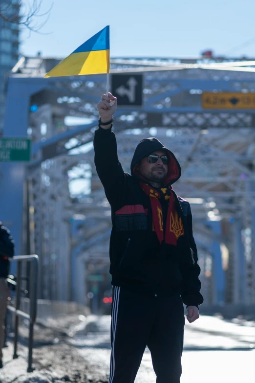 a man is holding his fist up in the air while he holds a flag