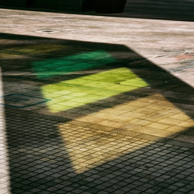 a shadow from the shadow of a tennis racquet on a ground