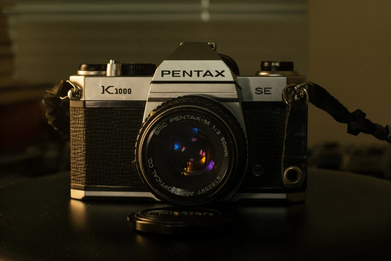 a pentax k - 100 with a flash drive attached