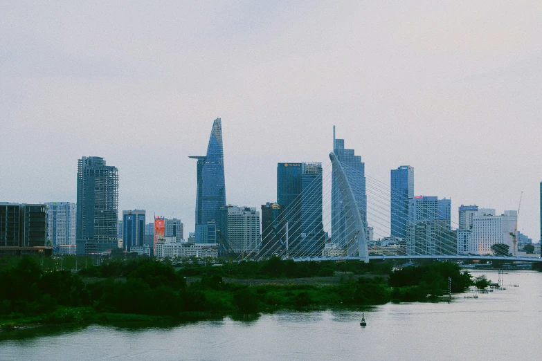 a city filled with tall buildings next to a river