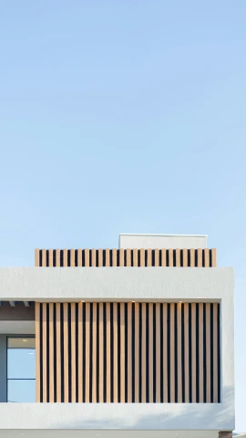 two birds sit on the ledge of a modern building