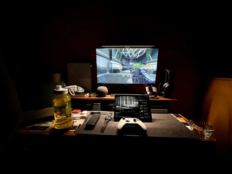 a computer is sitting on a desk with video game remote controls