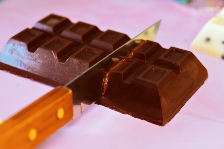 a cake knife cuts into chocolate squares and other items