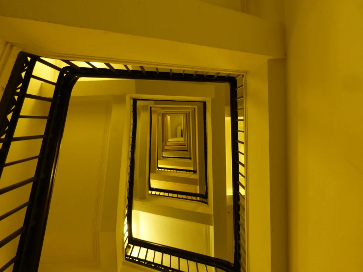 a hallway with a light on and several stairs