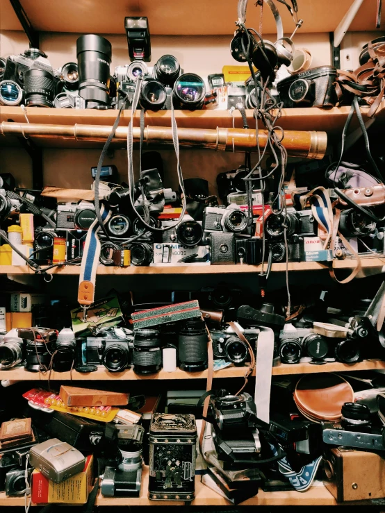 shelves filled with cameras and other items for sale