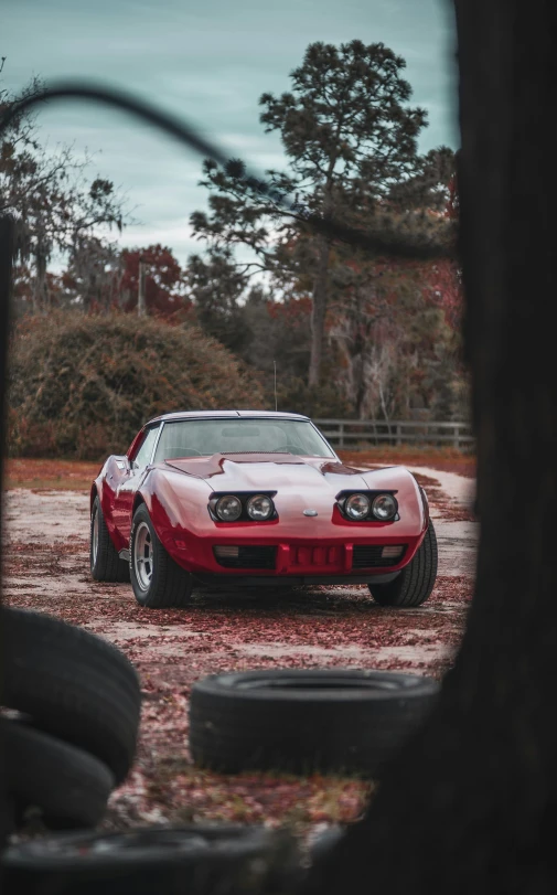 a red sports car parked on a paved lot