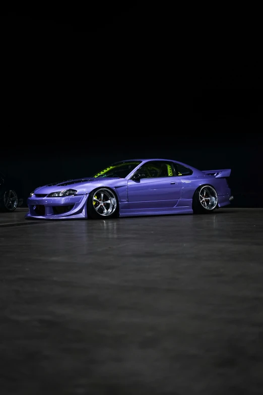 a purple bmw car is parked in the dark