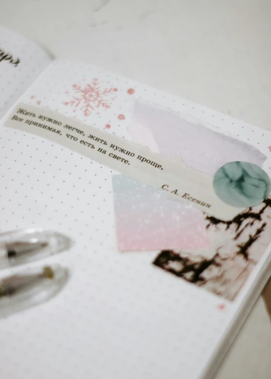 an opened notebook with several images of winter