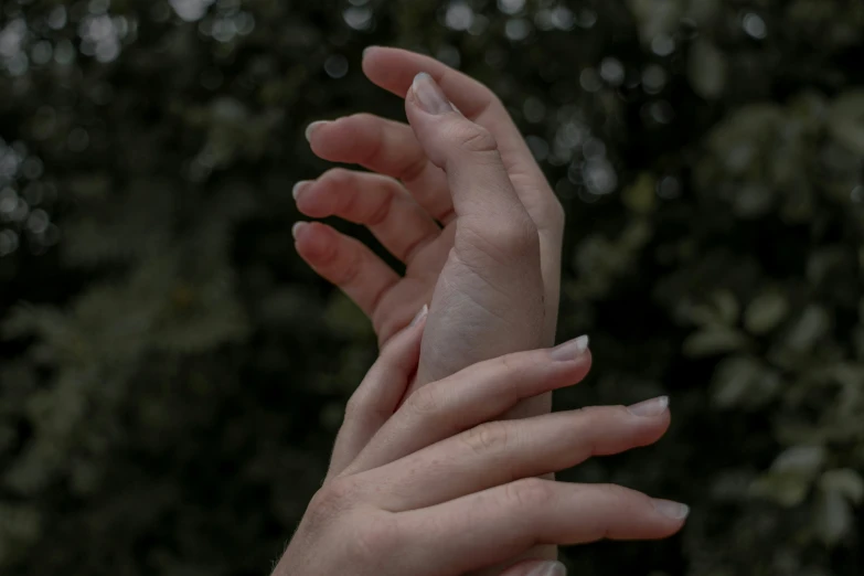 two people reaching into one another with their hands