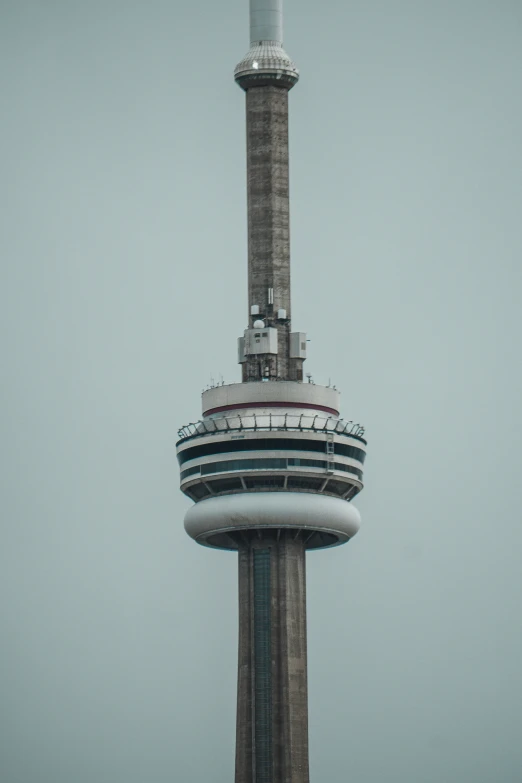 a very tall and slender building with a tv tower