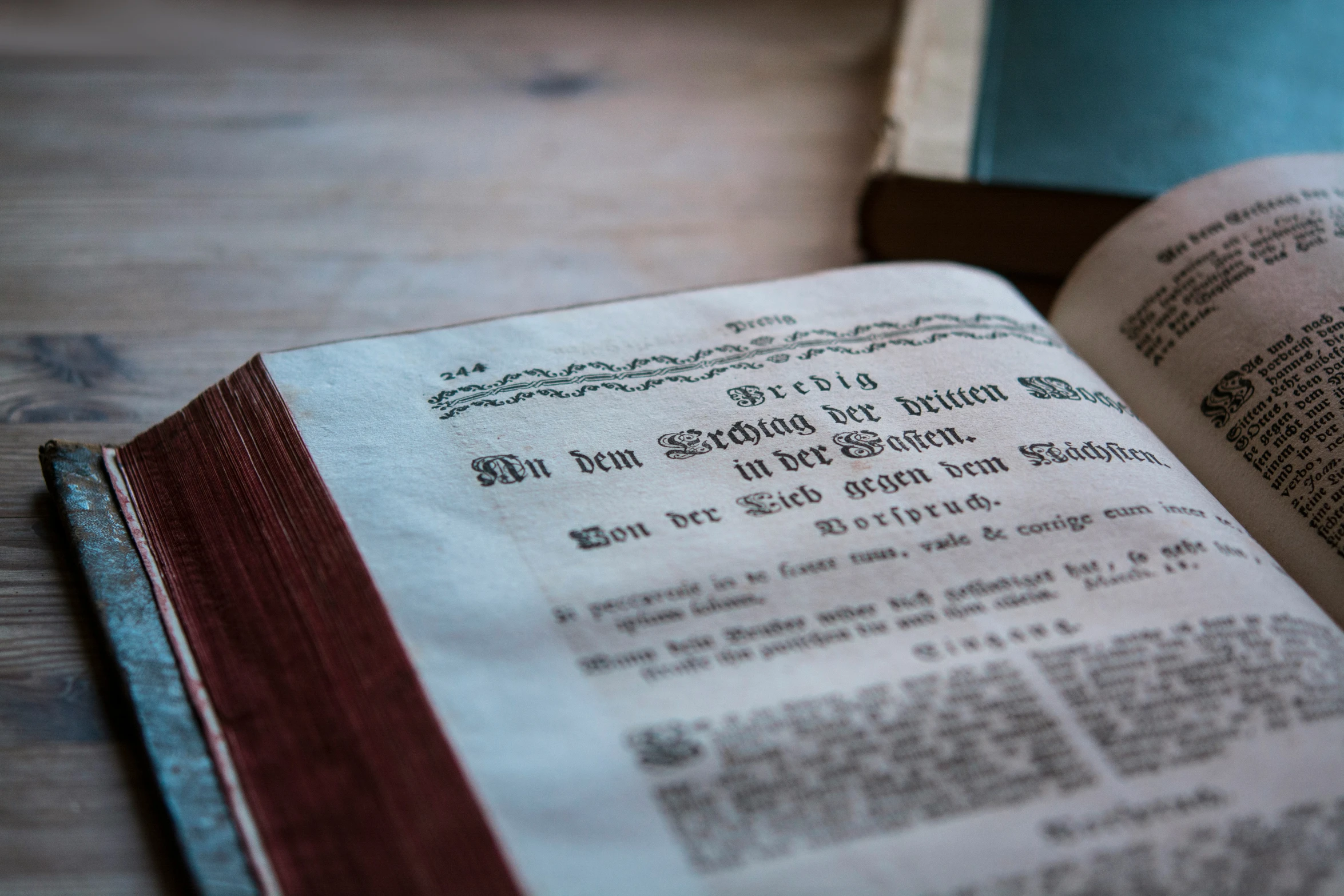 an old book sitting open on a wooden table