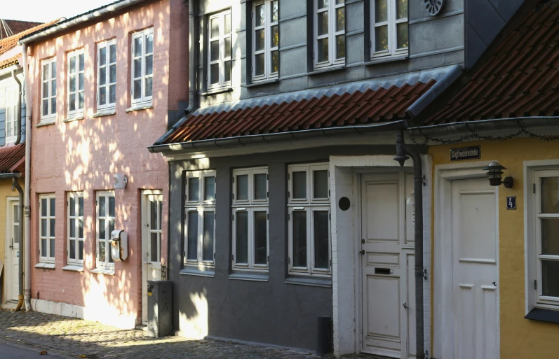 a row of brick buildings with white windows