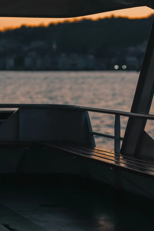 the front of a boat with sails and a view of a lake