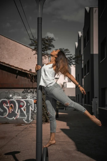 a girl that is standing on a pole