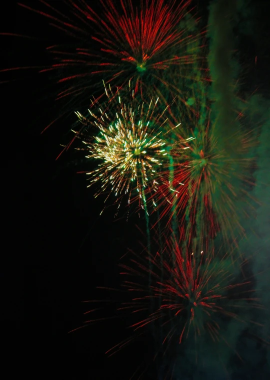 fireworks exploding in the dark sky during night time