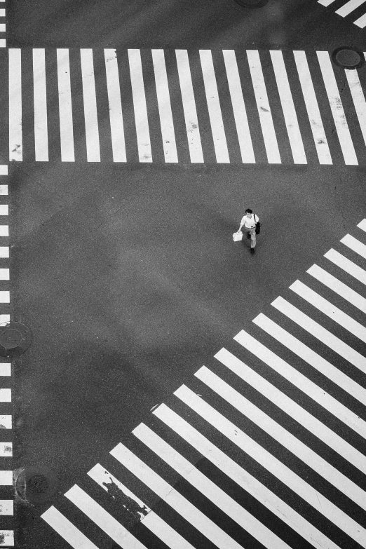 an aerial view shows people walking on a crosswalk