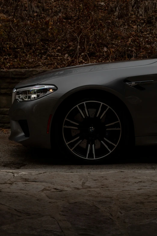 a gray car is parked on the side of the road