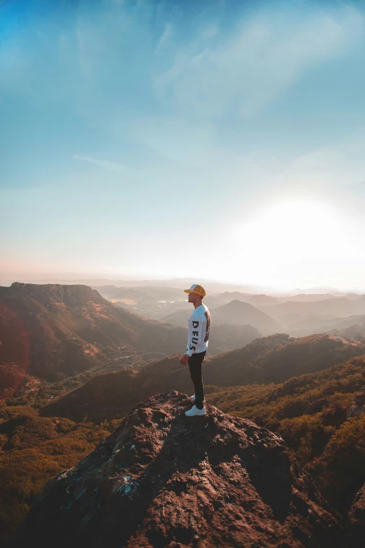 a man on top of a hill in the middle of the day