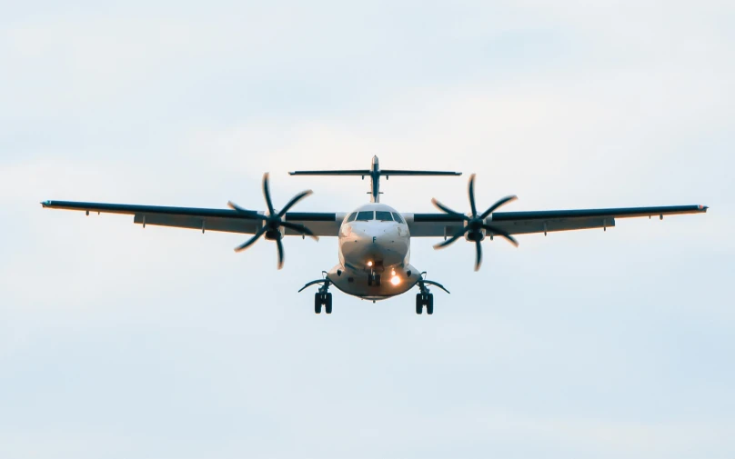 a large airplane flying through a blue sky