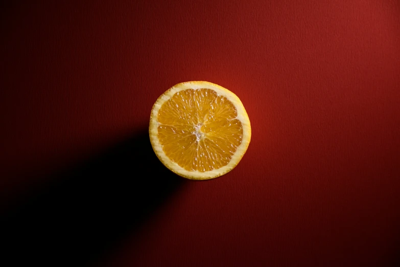 a cut orange that is sitting on the table