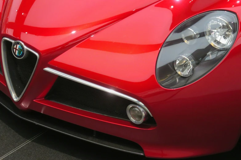 this is an interesting front end on a red sports car