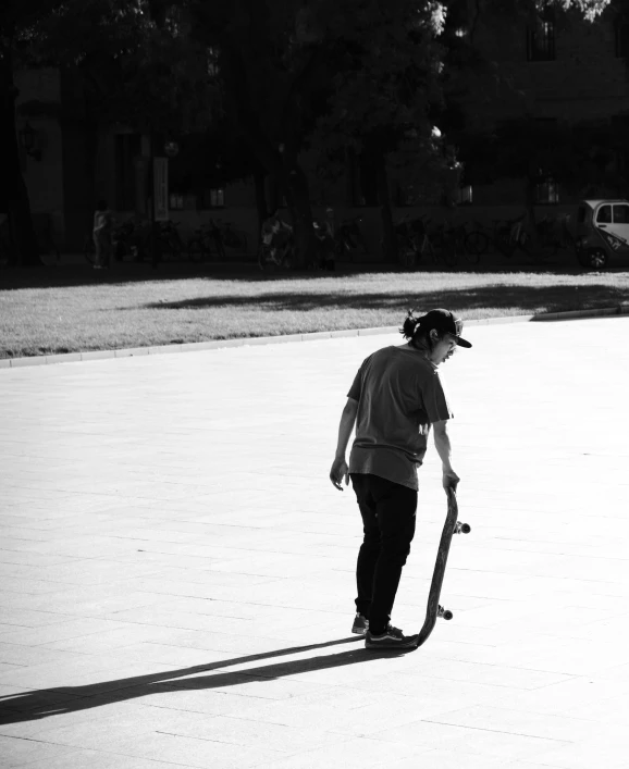 the person is skateboarding and riding his skateboard in the park