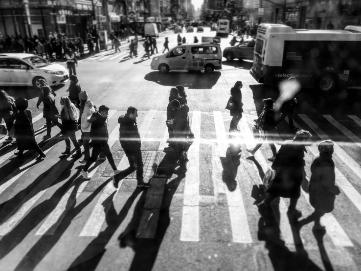 a black and white po with a lot of people walking down the street