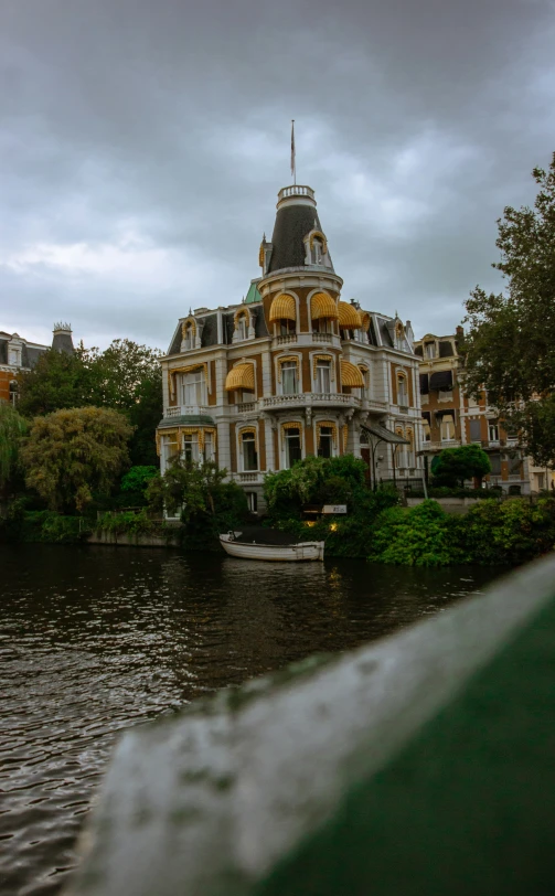 a big building on the water by some buildings