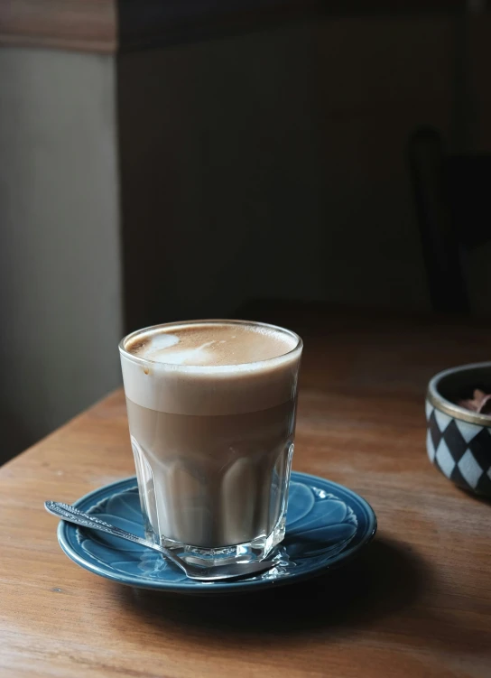 a close up of a glass of coffee on a table