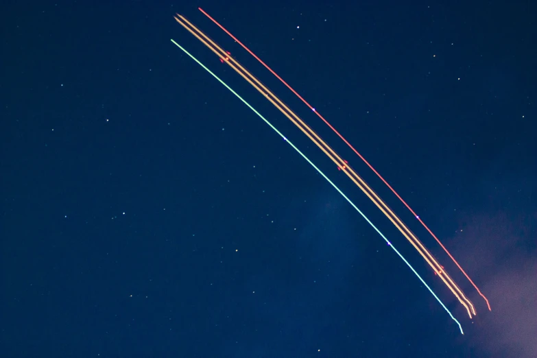 a plane flying in the dark with a star trails