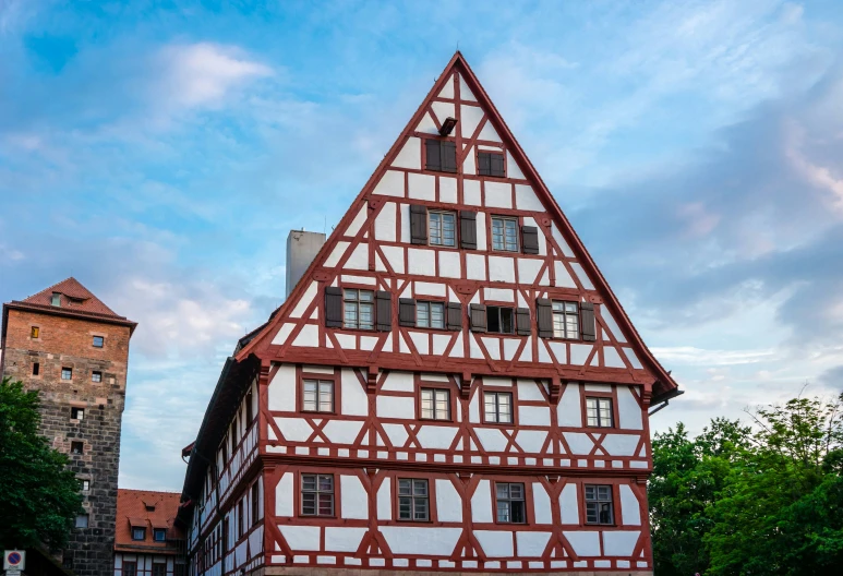 a large white and red building with windows on top