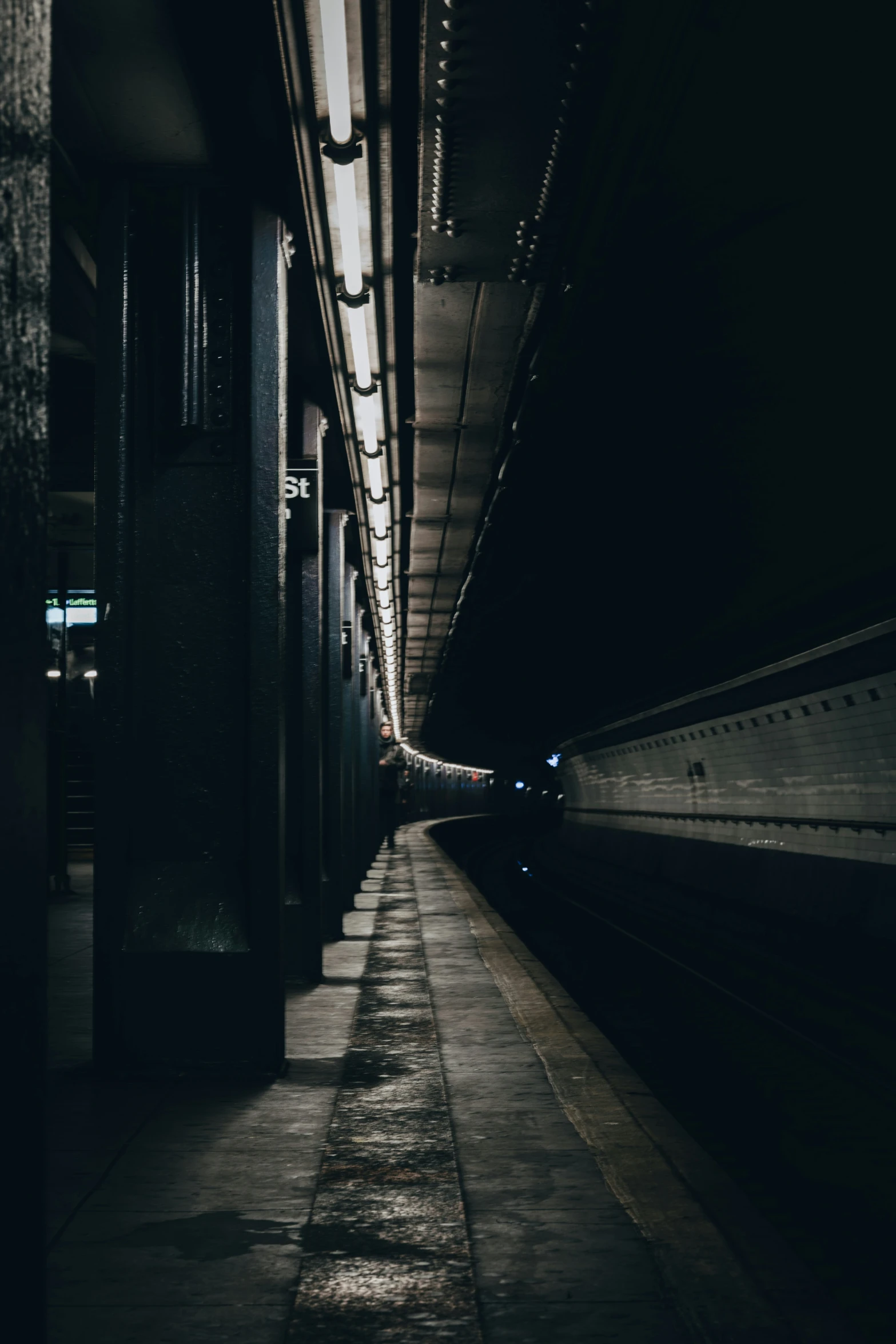 a train at night with one speeding down the tracks