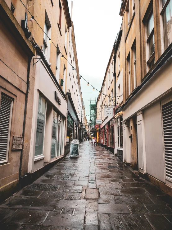 a narrow city street with buildings on both sides