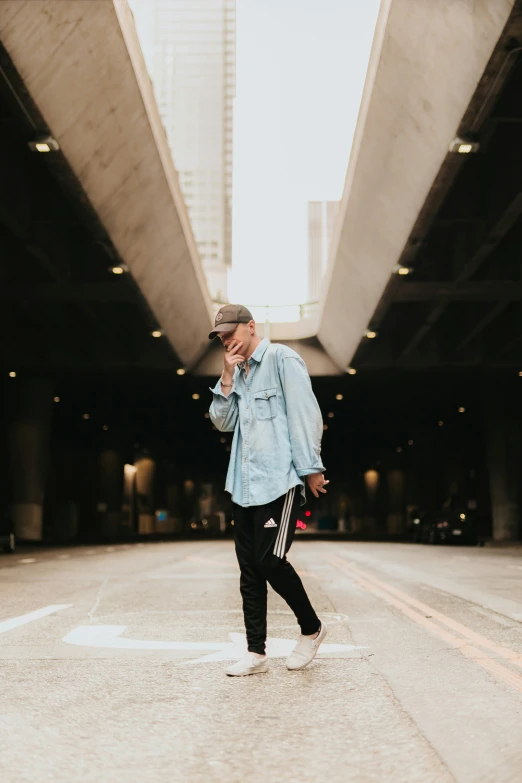 a man standing on a city street talking on his phone