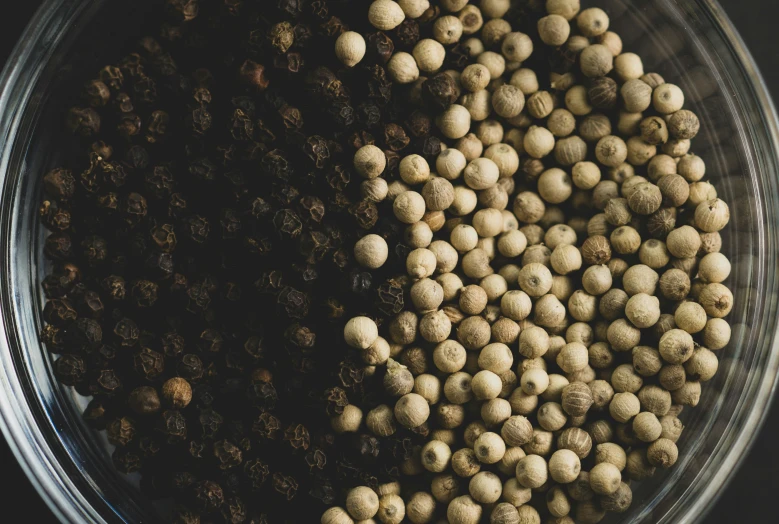 a close up of a bowl with small objects inside