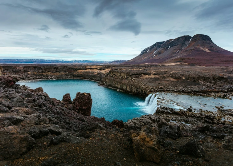 an empty pond with small waterfall in the middle