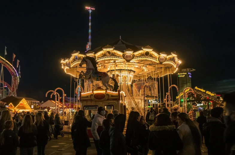 several people gather together at a carnival