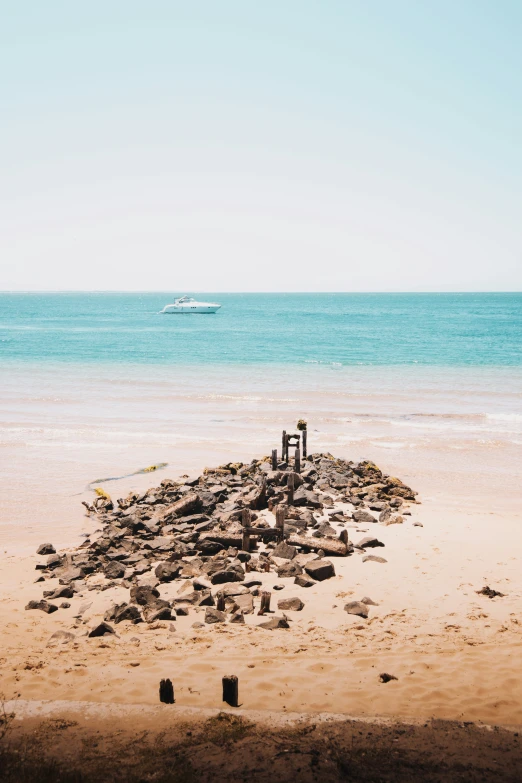 the shore line at the beach is covered with rocks