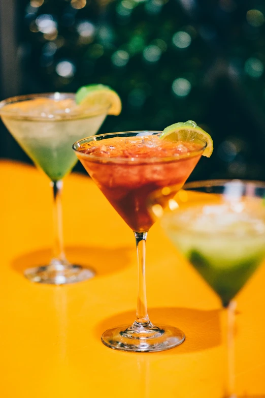 three different types of cocktails lined up on a table